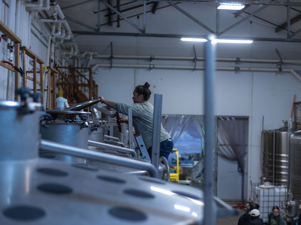 Image of McKenna in the winery securing a tank